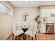 Dining area with a glass table and seating for four, next to the kitchen, offering an open and airy atmosphere at 1825 Kendall St # 107, Lakewood, CO 80214