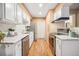 Updated kitchen featuring stainless steel appliances, white cabinetry, and a stylish backsplash at 1825 Kendall St # 107, Lakewood, CO 80214