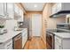 Modern kitchen with stainless steel appliances, white cabinets, and stone countertops at 1825 Kendall St # 107, Lakewood, CO 80214