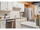 Beautiful kitchen featuring white cabinets, stainless steel appliances, and ample counter space at 1825 Kendall St # 107, Lakewood, CO 80214