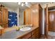 Bathroom with wood cabinets and a shower/tub combo at 14219 County Road 22, Fort Lupton, CO 80621