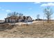 House exterior with landscaping and a windmill at 14219 County Road 22, Fort Lupton, CO 80621