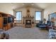 Spacious living room with a fireplace, large windows, and comfortable seating at 14219 County Road 22, Fort Lupton, CO 80621