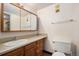 Small bathroom featuring geometric wallpaper, a single sink vanity and medicine cabinet at 14740 E Kentucky Dr # 716, Aurora, CO 80012