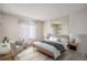 Bright bedroom with an accent mirror wall, plush carpet, and a cozy sitting area at 14740 E Kentucky Dr # 716, Aurora, CO 80012