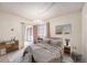 Bright main bedroom featuring a neutral color palette, chandelier, and sliding door to the outdoors at 14740 E Kentucky Dr # 716, Aurora, CO 80012