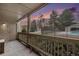 Covered patio showing railings with a view of trees, fencing and the sky at sunset at 14740 E Kentucky Dr # 716, Aurora, CO 80012