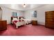 Cozy bedroom with two twin beds, wood dresser and carpeting at 6926 S Saulsbury St, Littleton, CO 80128