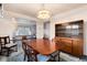 Classic dining room with a wood table, hutch, and view into the living room at 6926 S Saulsbury St, Littleton, CO 80128