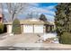 Brick ranch home with 3-car garage, landscaped yard, and partially visible snow at 6926 S Saulsbury St, Littleton, CO 80128