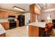 Bright kitchen with wood cabinets and stainless steel appliances at 6926 S Saulsbury St, Littleton, CO 80128