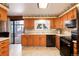 Spacious kitchen with wood cabinets and stainless steel appliances at 6926 S Saulsbury St, Littleton, CO 80128