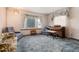 Living room featuring a bay window, comfortable seating, and a vintage organ at 6926 S Saulsbury St, Littleton, CO 80128