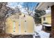 Yellow shed in backyard with snow on ground at 6926 S Saulsbury St, Littleton, CO 80128