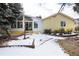 Backyard view of house with snow at 6926 S Saulsbury St, Littleton, CO 80128