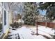 Snowy backyard with trees and landscaping at 6926 S Saulsbury St, Littleton, CO 80128