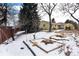 Snowy backyard with garden beds at 6926 S Saulsbury St, Littleton, CO 80128