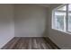 This bedroom features wood-look floors, fresh paint, and natural light from the window at 7042 W 76Th Ave, Arvada, CO 80003
