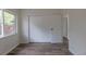 This spacious bedroom has new wood flooring, closet, and neutral paint for a calming space at 7042 W 76Th Ave, Arvada, CO 80003