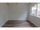 This bedroom features wood-look floors, fresh paint, and natural light from the window at 7042 W 76Th Ave, Arvada, CO 80003