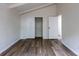 This spacious bedroom has new wood flooring, closet, and neutral paint for a calming space at 7042 W 76Th Ave, Arvada, CO 80003