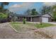 Charming single-story brick home featuring an attached garage, and fresh landscaping at 7042 W 76Th Ave, Arvada, CO 80003