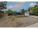 Inviting single-story home with a well-maintained lawn, an attached garage, and brick accents at 7042 W 76Th Ave, Arvada, CO 80003