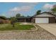 Well-kept single-story home featuring a brick exterior, attached garage, and manicured lawn at 7042 W 76Th Ave, Arvada, CO 80003