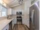 Kitchen features stainless appliances, white countertops, and shaker cabinets at 7042 W 76Th Ave, Arvada, CO 80003