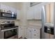 Updated stainless steel appliances compliment the light and bright kitchen at 7042 W 76Th Ave, Arvada, CO 80003