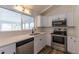 Cozy kitchen featuring shaker cabinets, subway tile backsplash, and stainless appliances at 7042 W 76Th Ave, Arvada, CO 80003