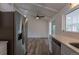 Bright kitchen features stainless steel appliances, light countertops, and updated cabinets at 7042 W 76Th Ave, Arvada, CO 80003