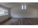 Open-concept living room with large window with a view of the front yard at 7042 W 76Th Ave, Arvada, CO 80003