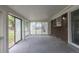 Enclosed sunroom with large windows for natural light and brick accents at 7042 W 76Th Ave, Arvada, CO 80003