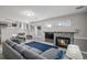 Cozy living room featuring a fireplace, plush sectional sofa, and a calming blue rug at 10780 Wheatfield Ln, Parker, CO 80138