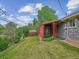 Large, grassy backyard featuring a sunroom, providing ample space for outdoor activities at 423 Empire St, Aurora, CO 80010