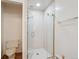 Modern bathroom with a glass-enclosed shower, toilet, and sleek design at 423 Empire St, Aurora, CO 80010