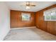 Bedroom featuring wood paneled walls, carpet and natural light at 423 Empire St, Aurora, CO 80010