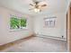 Sunlit bedroom with neutral walls, carpeted floors, two windows and closet at 423 Empire St, Aurora, CO 80010
