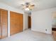 Bright bedroom with carpeted floor, and a closet with louvred doors at 423 Empire St, Aurora, CO 80010
