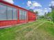 Side exterior view showcasing the sunroom and yard at 423 Empire St, Aurora, CO 80010