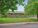 Brick ranch-style house with well-maintained lawn and mature trees at 423 Empire St, Aurora, CO 80010