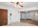 An open living space with classic features like a vintage phone, ceiling fan, and an arched entryway at 423 Empire St, Aurora, CO 80010