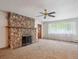 Living room with stone fireplace, carpet and natural light at 423 Empire St, Aurora, CO 80010