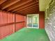 Cozy back patio with wooden walls offering privacy and an entrance to the sunroom at 423 Empire St, Aurora, CO 80010