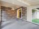 Covered patio with brick and concrete flooring, along with a ceiling fan and sliding glass door at 423 Empire St, Aurora, CO 80010