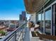 Relaxing balcony featuring an outdoor kitchen, comfortable seating, and stunning city views at 2001 Lincoln St # 1822, Denver, CO 80202