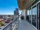 Balcony featuring glass railings and a city view of Denver, Colorado at 2001 Lincoln St # 1822, Denver, CO 80202