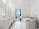 Bright bathroom featuring a soaking tub and a glass enclosed shower with double sink vanity at 2001 Lincoln St # 1822, Denver, CO 80202