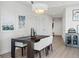 Dining area boasts a dark wood table, seating for four, and modern pendant lighting at 2001 Lincoln St # 1822, Denver, CO 80202